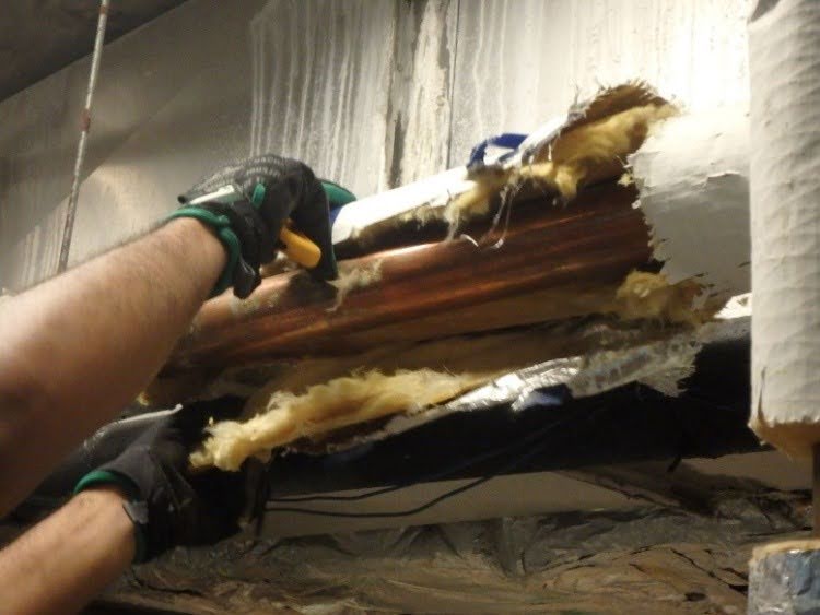 Figure 2. Insulation is being removed and the piping is exposed.